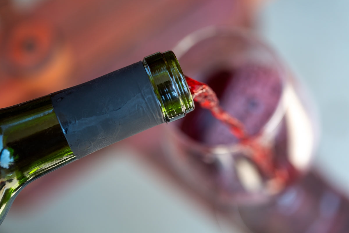 a bottle of wine being poured into a glass