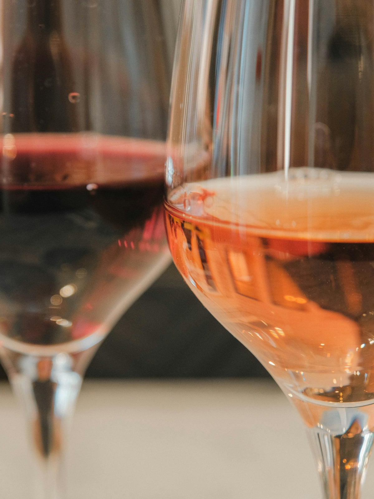 Two glasses of wine, one red, one rosé.
