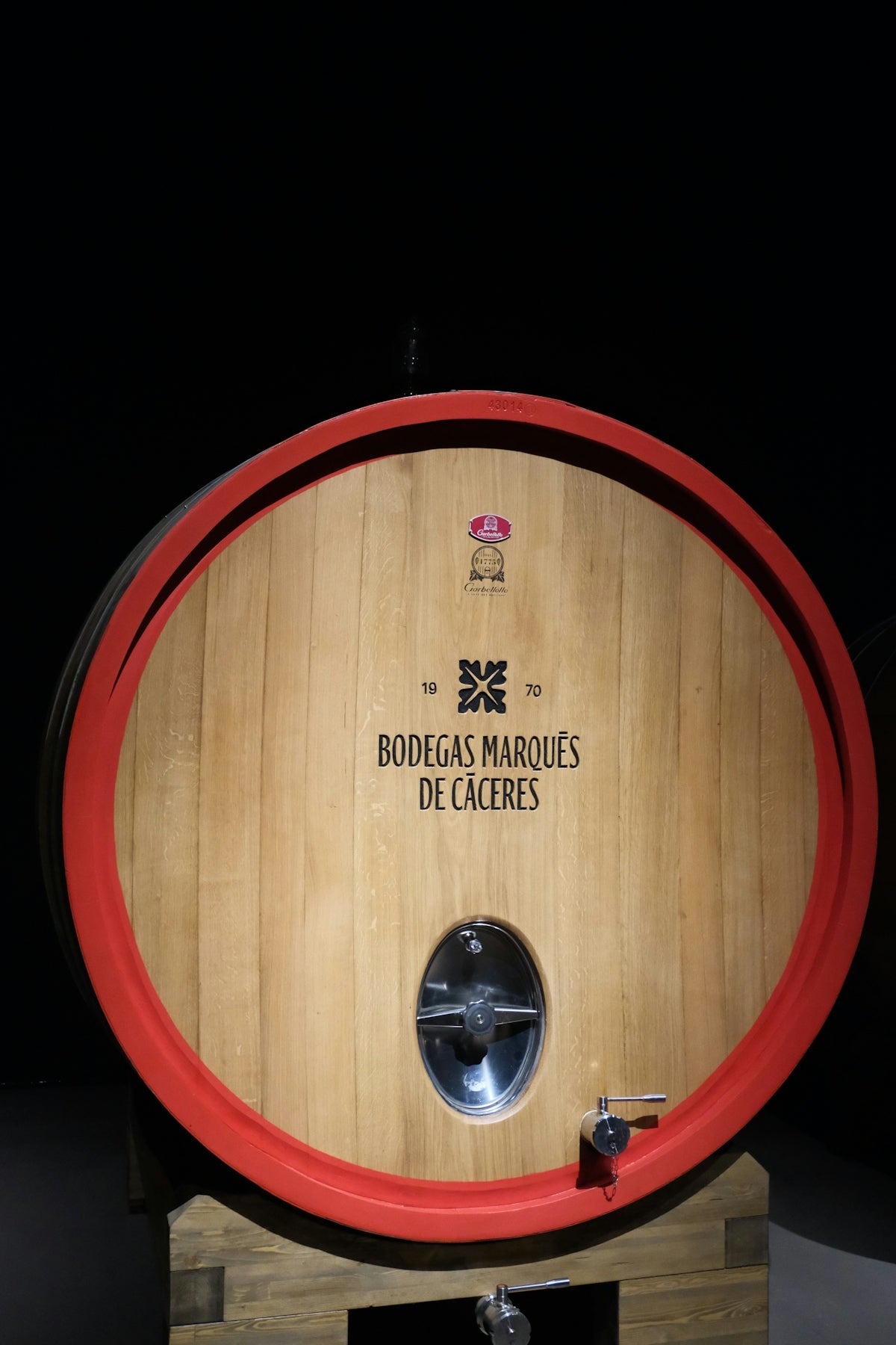 Wooden wine barrel with red rim and tap